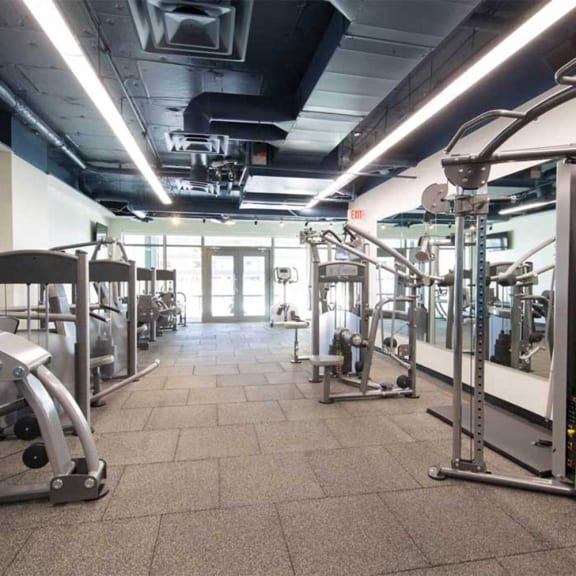 the inside of a gym with weights and cardio equipment at Versus, Calgary, Alberta