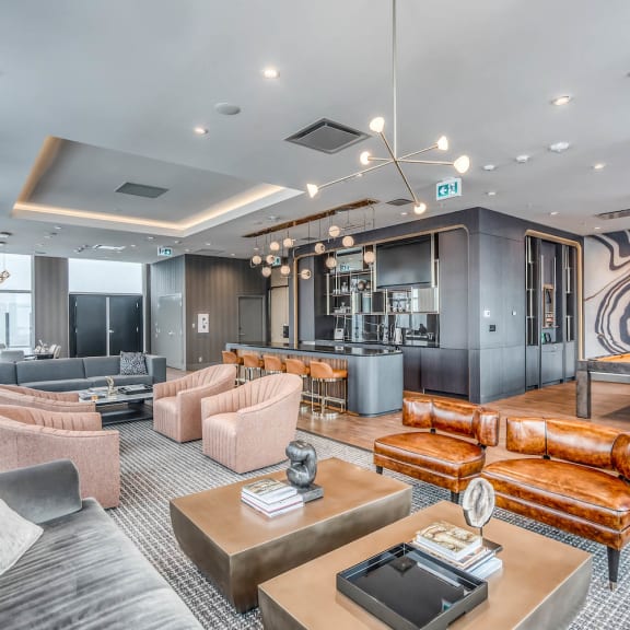 a living room with couches and chairs and a bar at BLVD Beltline, Calgary