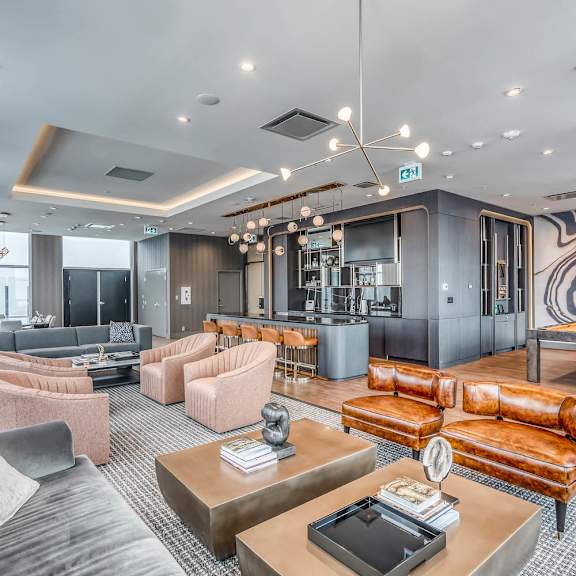 A modern living room with a grey and pink color scheme.