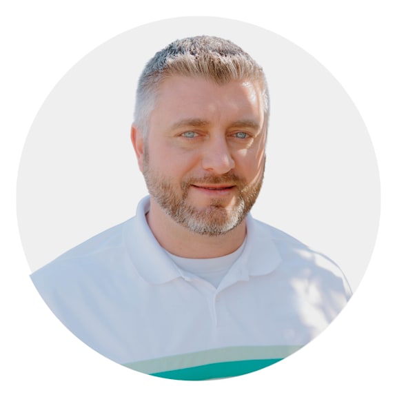 a man with a beard wearing a white shirt