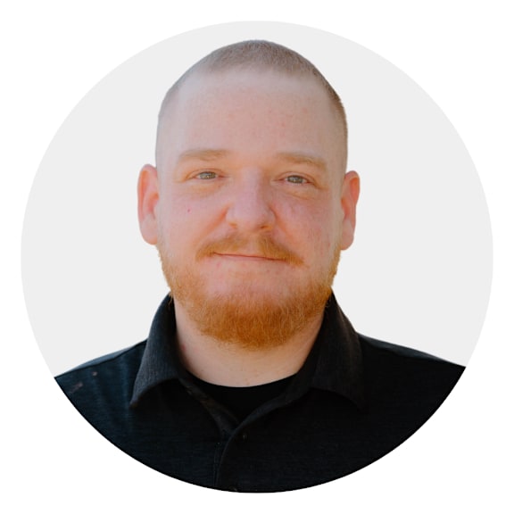 a headshot of a man with a red beard