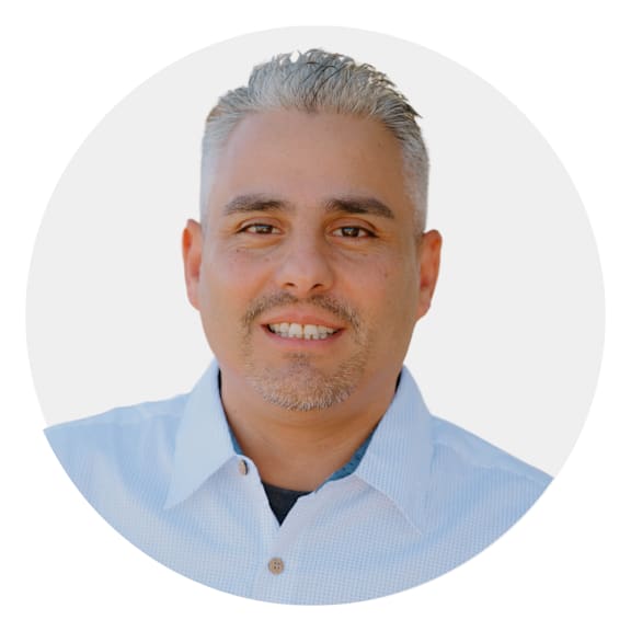 a man with gray hair wearing a blue shirt