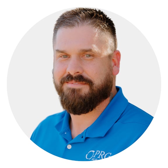a man wearing a blue shirt with a beard