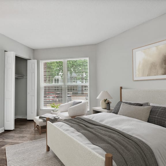 Model Bedroom with Double Closets and Wood-Style Flooring at Arbor Village Apartments in Charlotte, NC-INNER.