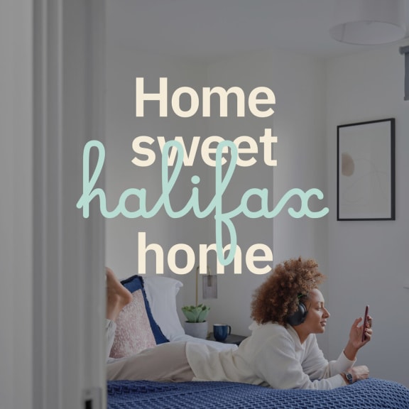 a couple laying on a bed with the words home sweet halifax home in the foreground