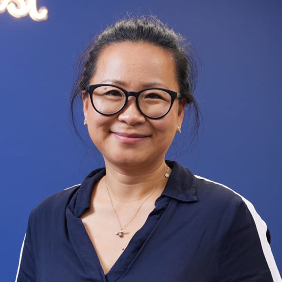 a woman wearing glasses and a blue shirt