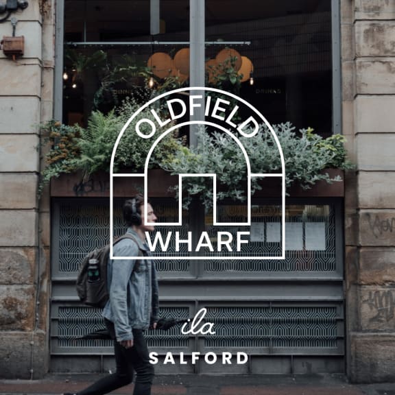 a man walking past an oldfield wharf store window