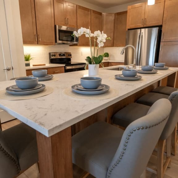 a kitchen with a marble counter top with plates and bowls on it