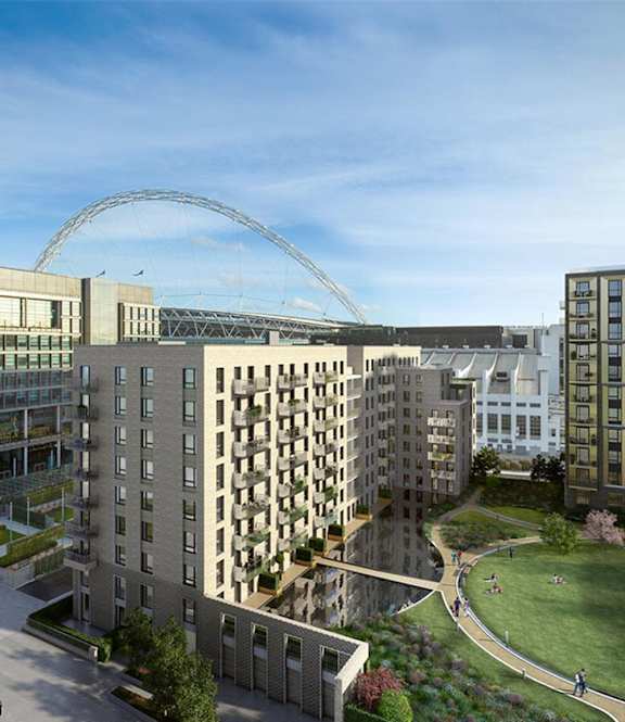 A modern building complex with a large arched structure in the background.
