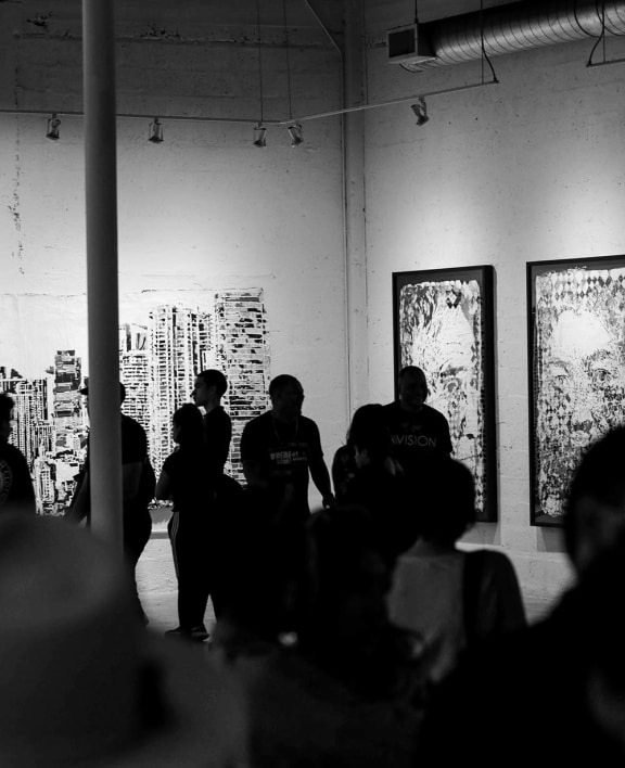a group of people standing around a room