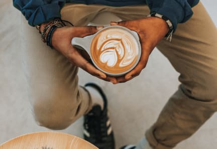 a man holding a cup of coffee