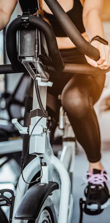 A person's foot is raised off the ground while exercising on a treadmill.