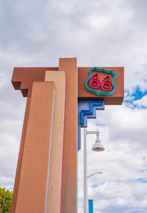 A wooden bridge with metal railings spans across a body of water.