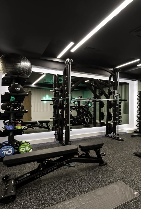 a home gym with weights and a motorcycle in the background