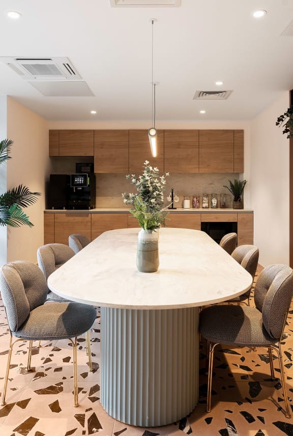 a dining room with a table and chairs and a kitchen