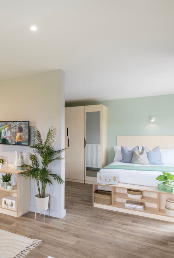 a bedroom with a bed with blue and white pillows