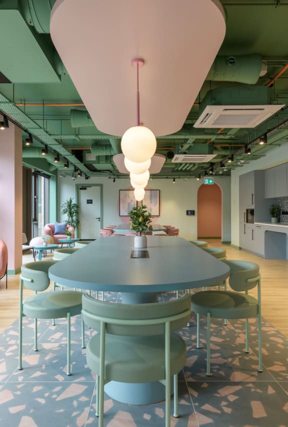 a restaurant with pink stools and tables