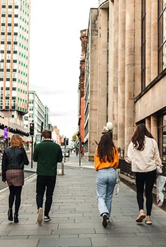 a group of people walking down a city street