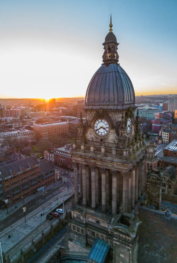 a clock tower on top of a building in a city