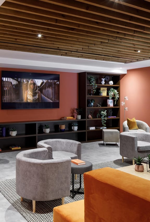 a living room with couches and chairs and a television