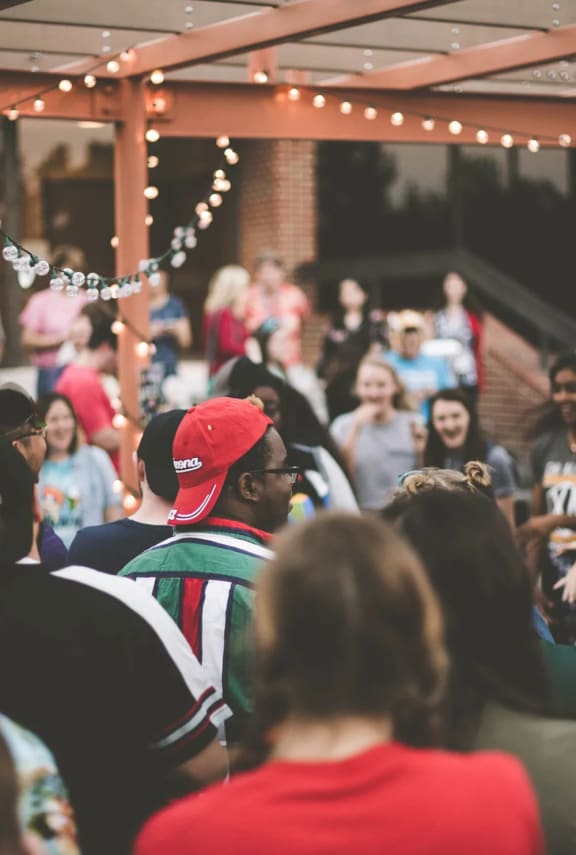 a group of people standing around in a crowd