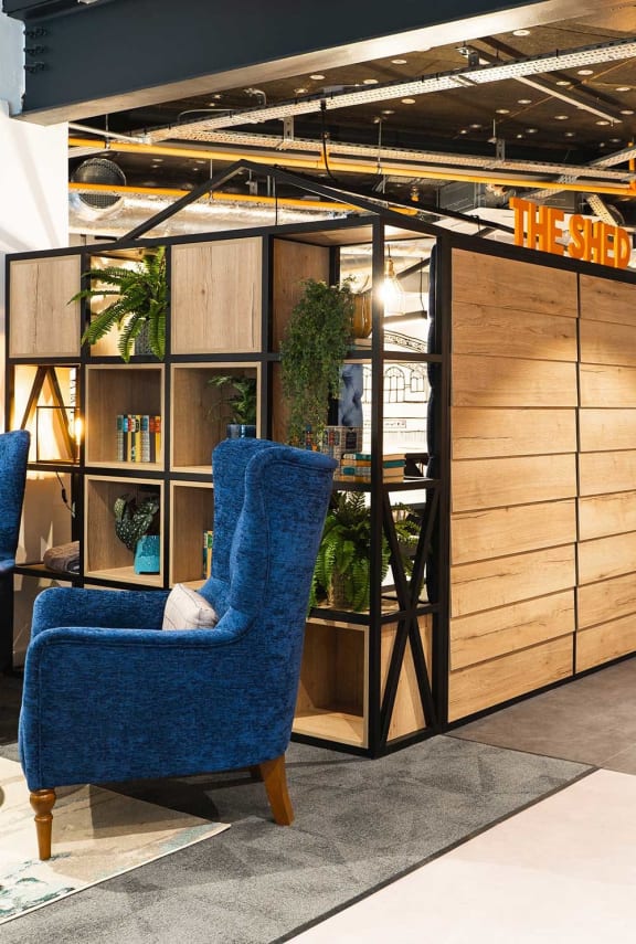 a blue chair sitting in front of a glass wall