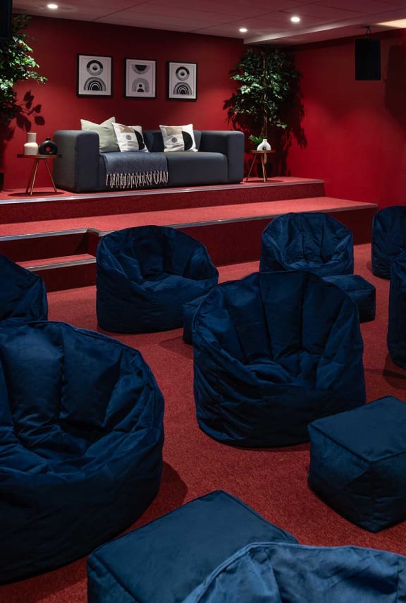 a living room with blue chairs and a couch