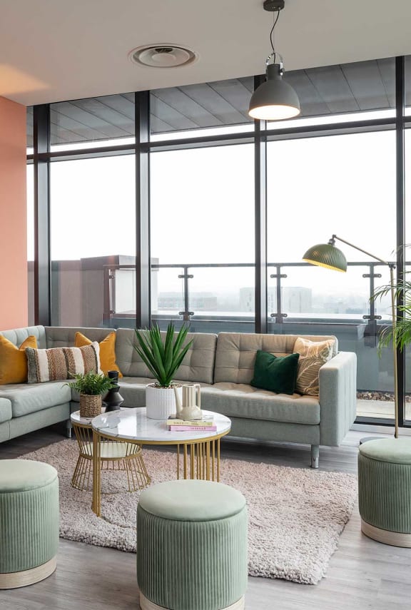 a living room with couches and a table in front of a window