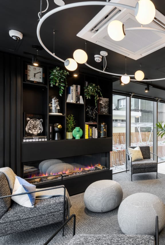 a living room with furniture and a round mirror