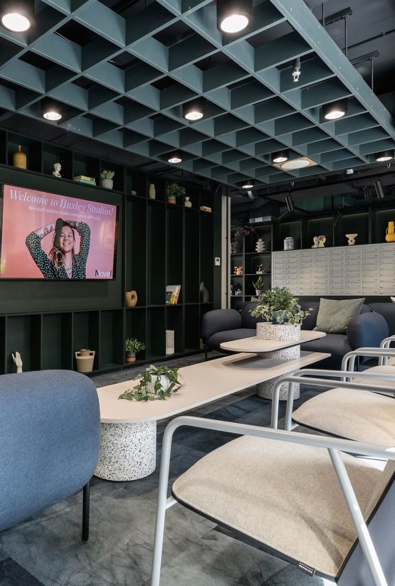 a conference room with tables and chairs and a television