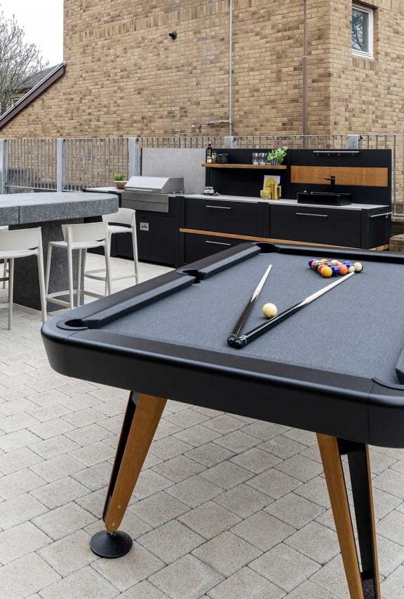 a pool table in the outdoor area of a bar