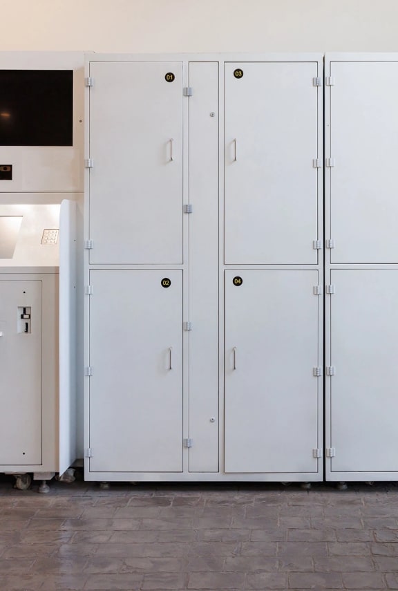a row of white storage lockers in a kitchen