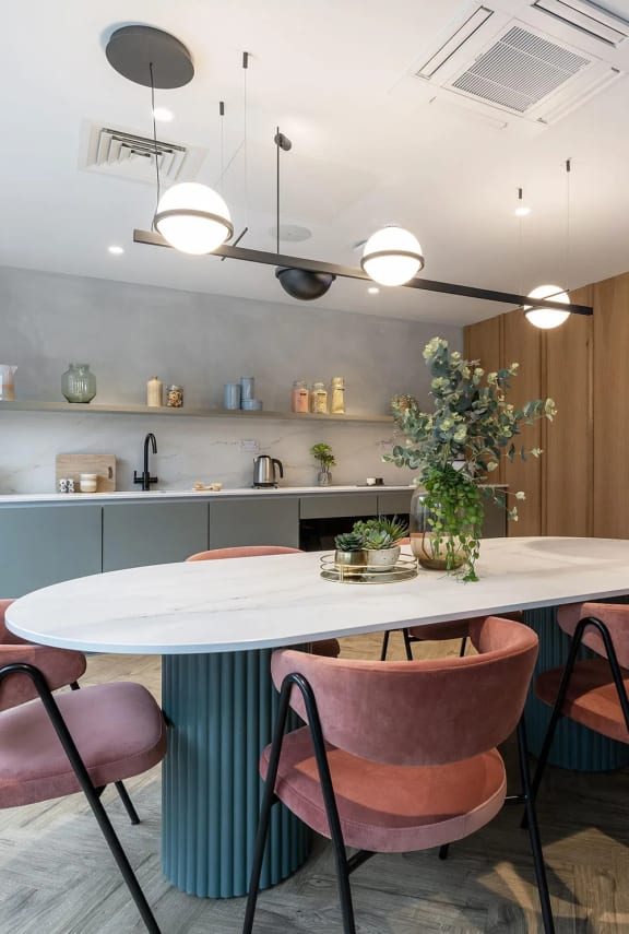 a kitchen and dining room with a table and chairs