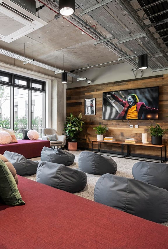 a living room with pillows and a couch and a tv
