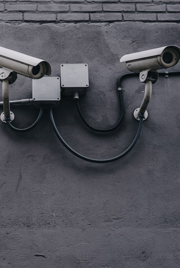 a pair of security cameras on a wall