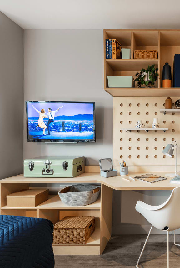 a home office with a desk and a tv