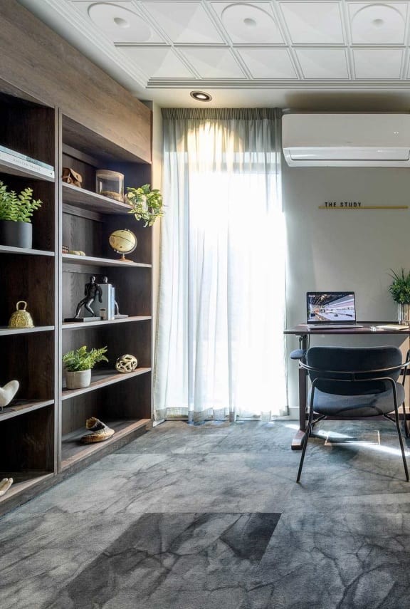 a room with a desk and a chair and a window