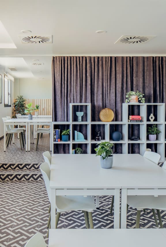 a dining room with a white table and chairs
