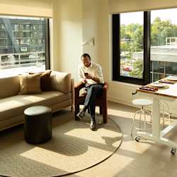 Man sitting on chair in living room at Scout Living, powered by Placemakr, Atlanta
