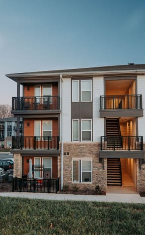 an apartment building with balconies and stairs at dusk at Preston Ridge, North Carolina
