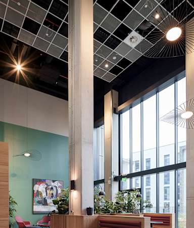 A reception area with a long wooden desk and a large window.
