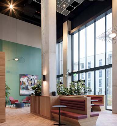 A reception area with a long wooden desk and a large window.