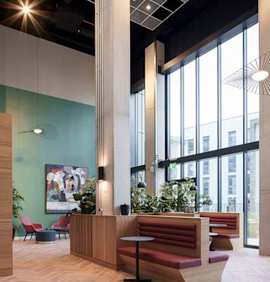 A reception area with a long wooden desk and a large window at Cherrywood Apartments, D18 VY3V, DUBLIN 18