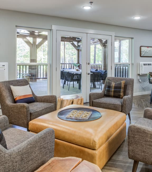 a living room with couches and chairs and a dining room with tables