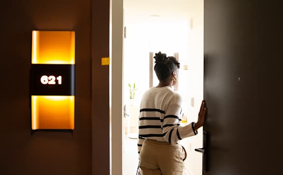 Woman entering her furnished apartment at Scout Living, powered by Placemakr, Atlanta, GA, 30308