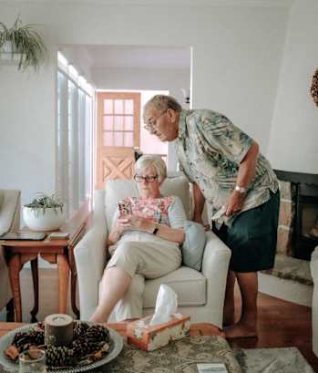 a woman sitting in a chair next to a man