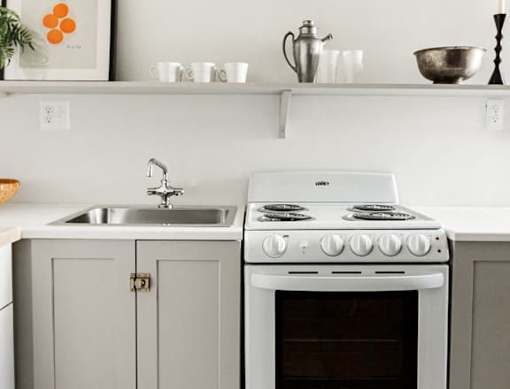 a white kitchen with white appliances and white cabinets