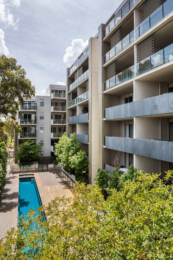 an apartment building with a swimming pool in front of it