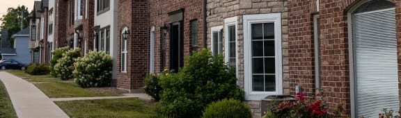 a brick house with a white door and window