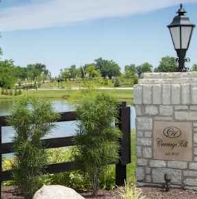 A stone wall with a lamp post and a sign that says "Cedar Grove".